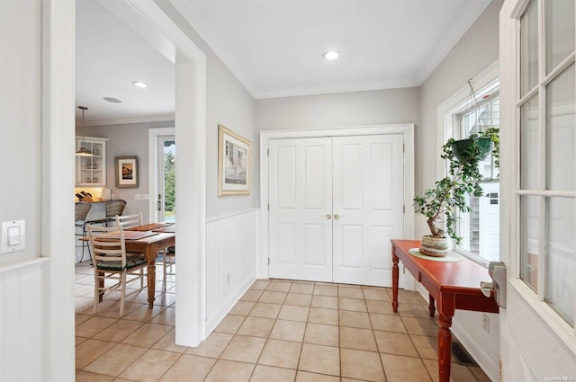 tiled entryway featuring ornamental molding