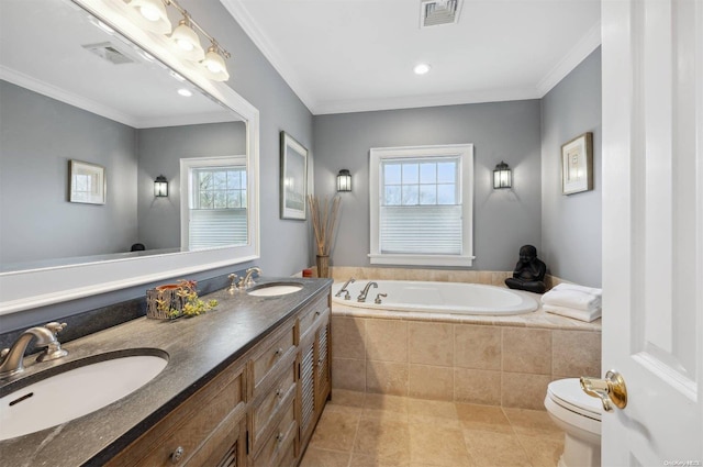 bathroom with tile patterned flooring, tiled tub, crown molding, toilet, and vanity