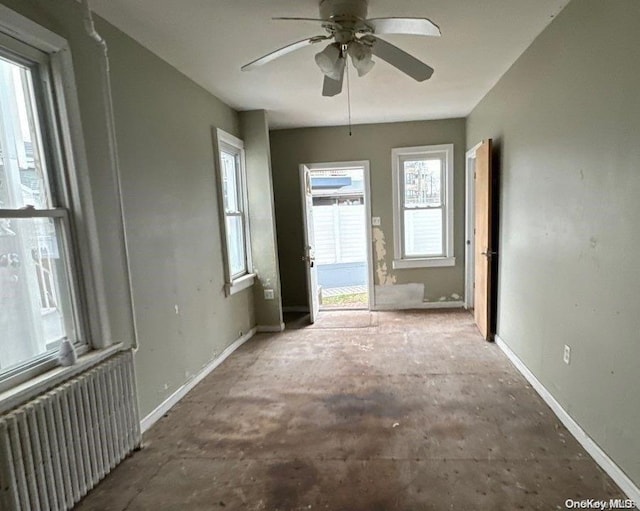 spare room featuring ceiling fan and radiator heating unit