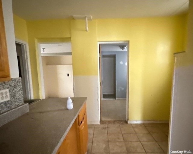 corridor featuring light tile patterned flooring