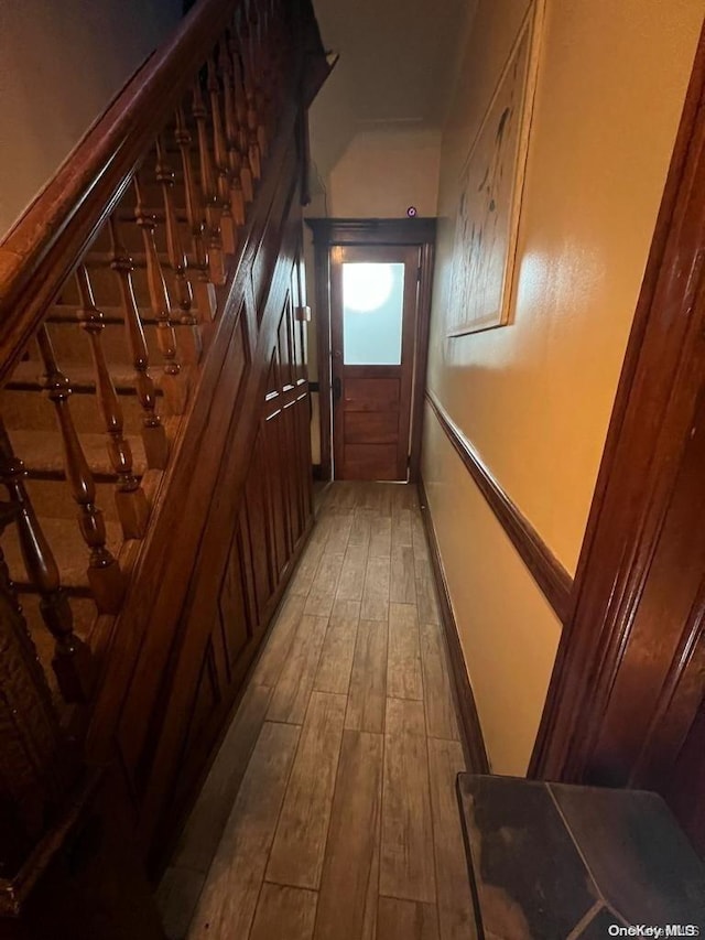 hall with hardwood / wood-style floors