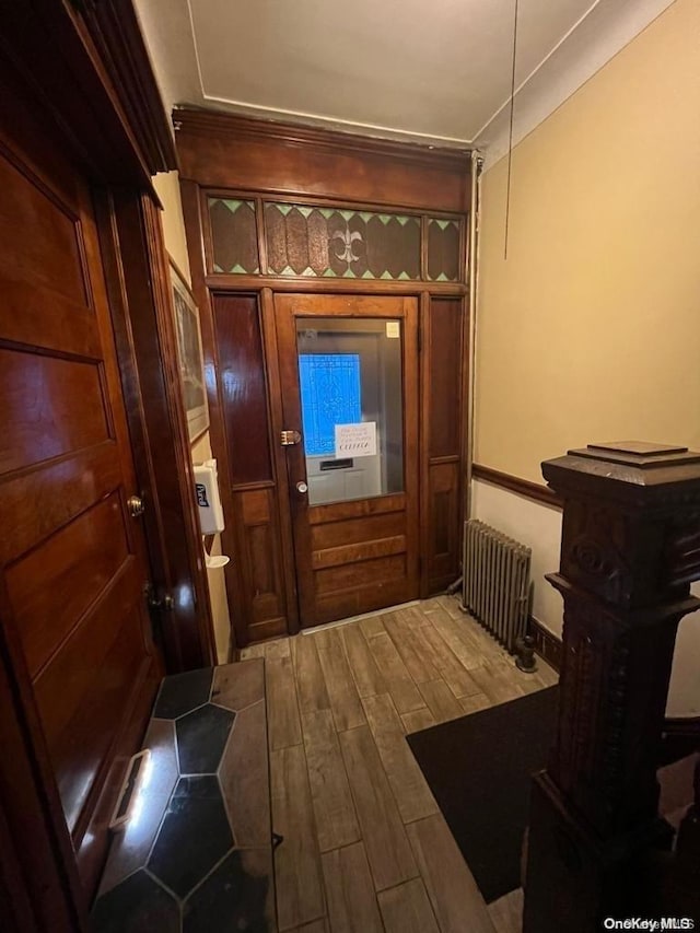 entryway featuring radiator and hardwood / wood-style floors