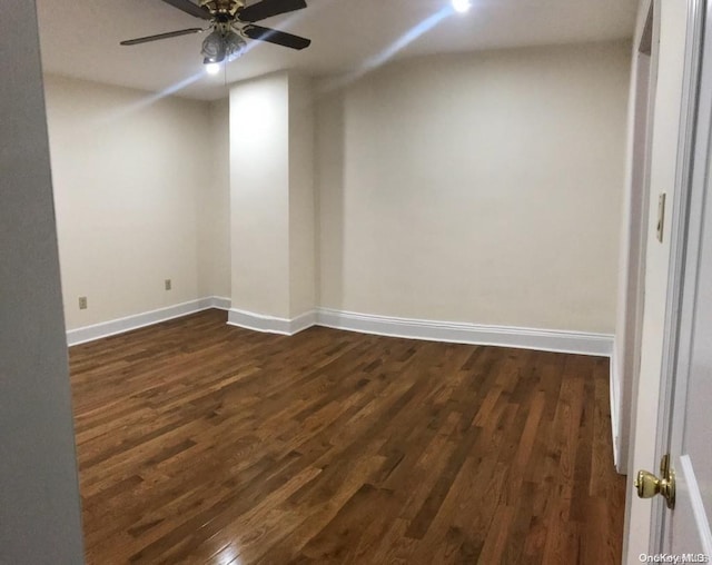 unfurnished room featuring ceiling fan and dark wood-type flooring