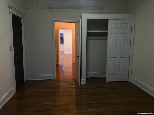 453 Ridgewood Ave, Brooklyn, NY 11208 - unfurnished bedroom featuring dark wood-style flooring, baseboards, and a closet