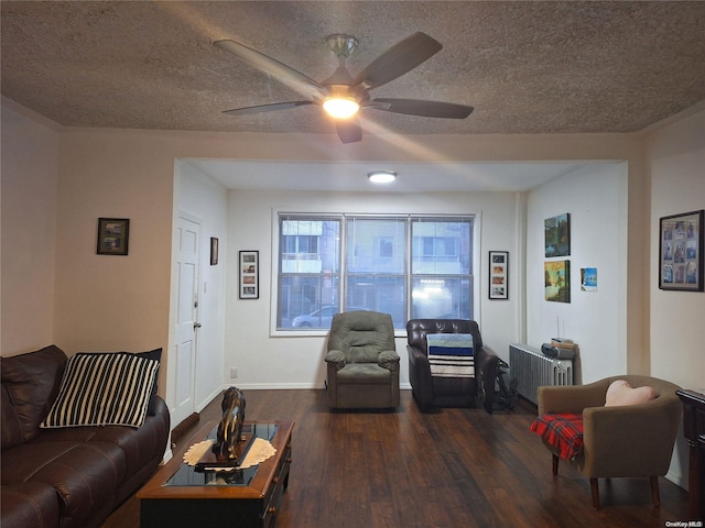 living room featuring radiator heating unit, dark hardwood / wood-style flooring, a textured ceiling, and ceiling fan