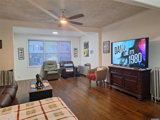 living room featuring radiator, dark wood-type flooring, and a textured ceiling