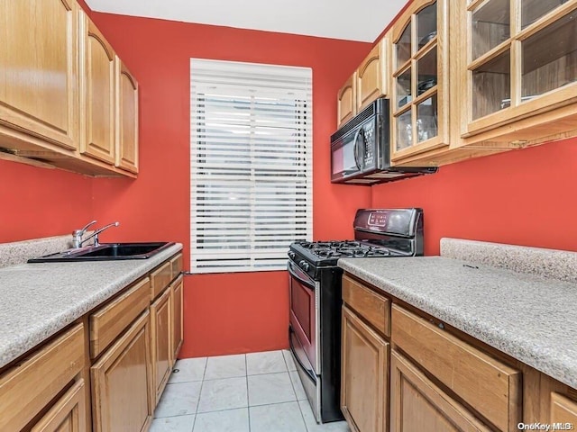 kitchen with sink, light tile patterned floors, and black appliances