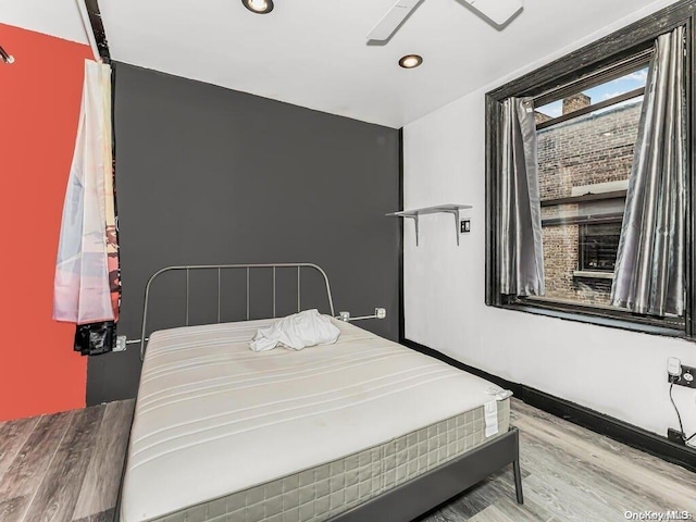 bedroom featuring ceiling fan and light hardwood / wood-style flooring