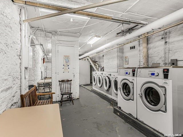 clothes washing area with washer and clothes dryer