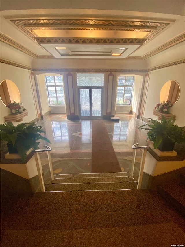 corridor with crown molding and french doors