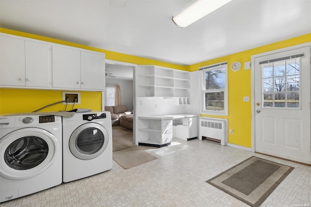 laundry area with cabinets, washer and clothes dryer, and radiator