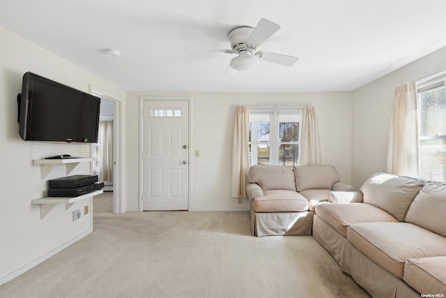 carpeted living room with plenty of natural light and ceiling fan