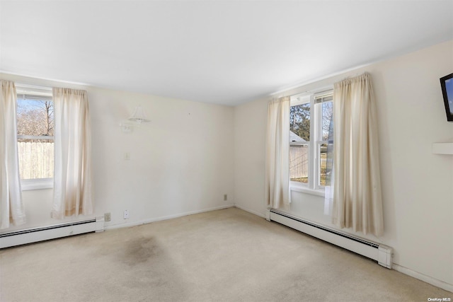 carpeted empty room with a baseboard heating unit