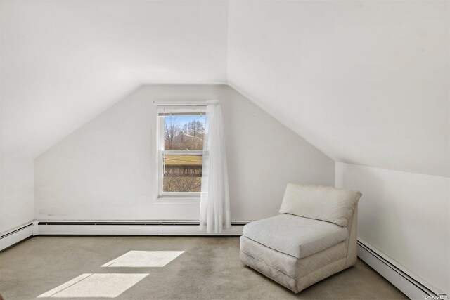 additional living space featuring light colored carpet, vaulted ceiling, and a baseboard heating unit