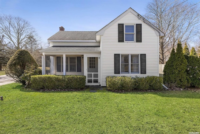 front facade with a sunroom and a front yard