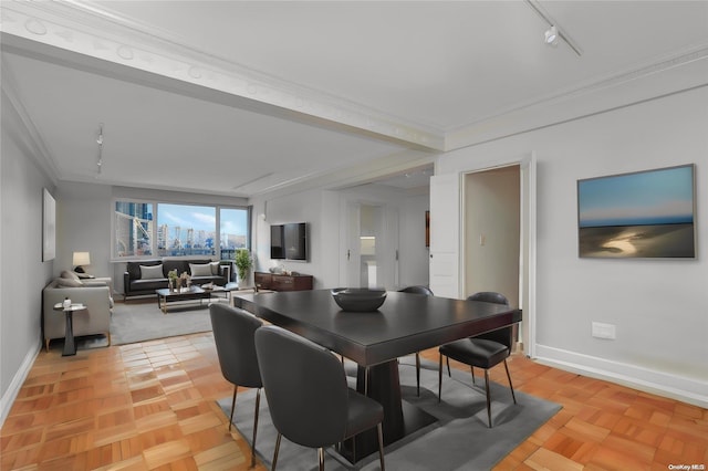 dining space with light parquet flooring, rail lighting, and crown molding