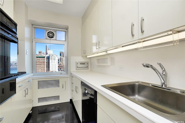 kitchen featuring black appliances, white cabinets, and sink