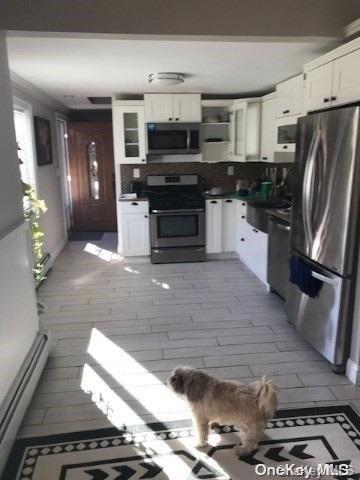 kitchen with white cabinetry and stainless steel appliances