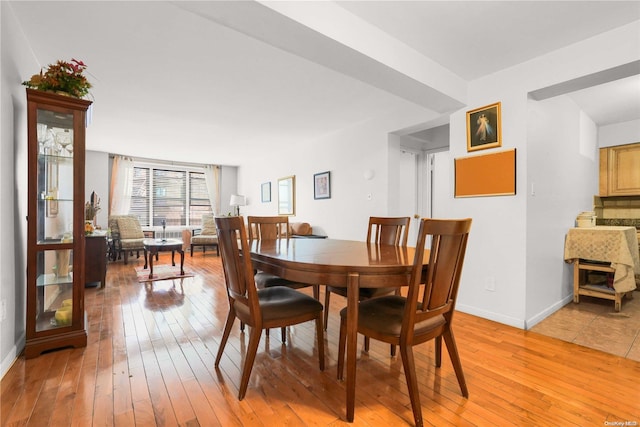 dining space with light hardwood / wood-style flooring