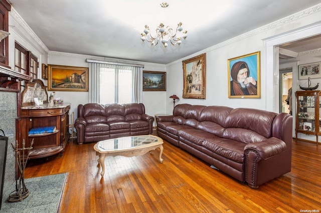 living room with ornamental molding, dark hardwood / wood-style floors, and an inviting chandelier