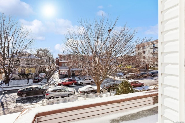 view of snow covered back of property