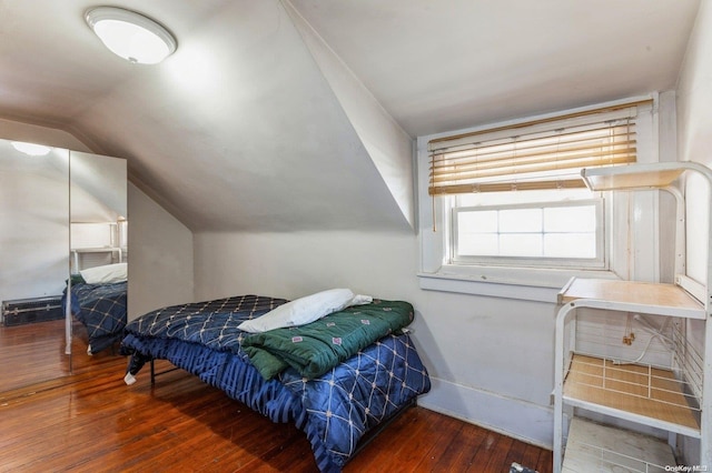 bedroom featuring dark hardwood / wood-style floors and vaulted ceiling