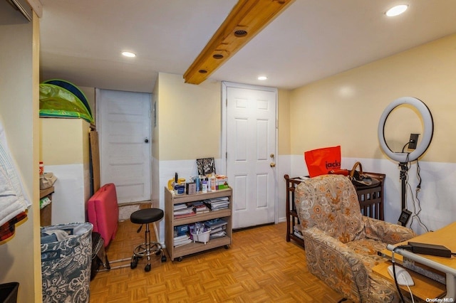 living area featuring beamed ceiling and light parquet floors