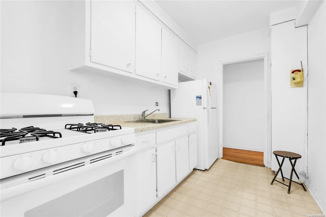 kitchen with white cabinets, white appliances, and sink