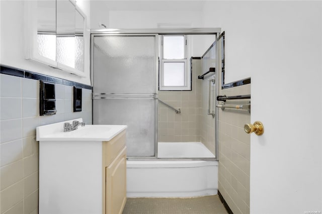 bathroom featuring tile patterned flooring, a healthy amount of sunlight, and tile walls