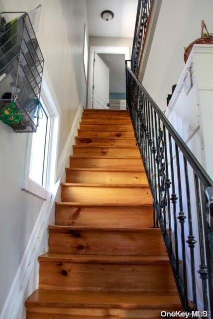 stairs featuring hardwood / wood-style flooring