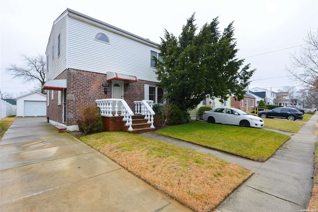 view of front of home featuring an outbuilding, a front yard, and a garage