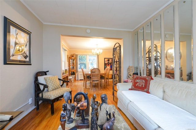 living room featuring a chandelier, hardwood / wood-style flooring, and crown molding