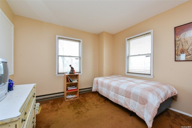 bedroom with a baseboard radiator and dark colored carpet