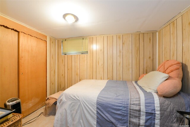 carpeted bedroom with wood walls