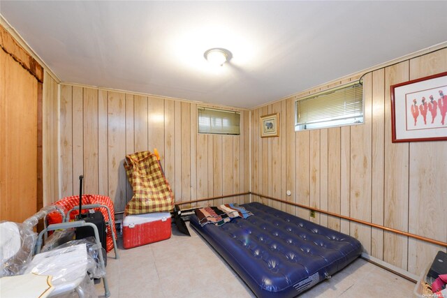 bedroom featuring wood walls