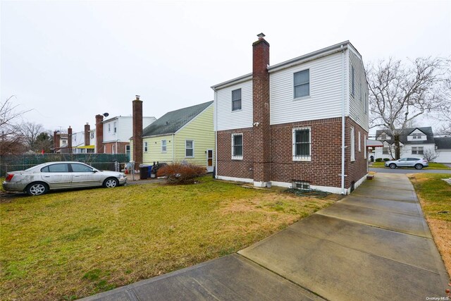 view of home's exterior with a lawn