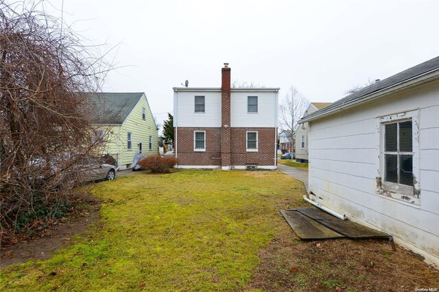 rear view of property with a yard