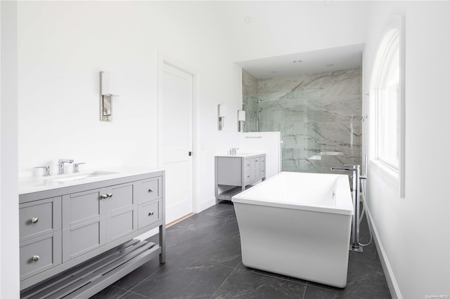 bathroom featuring tile patterned flooring, vanity, and separate shower and tub