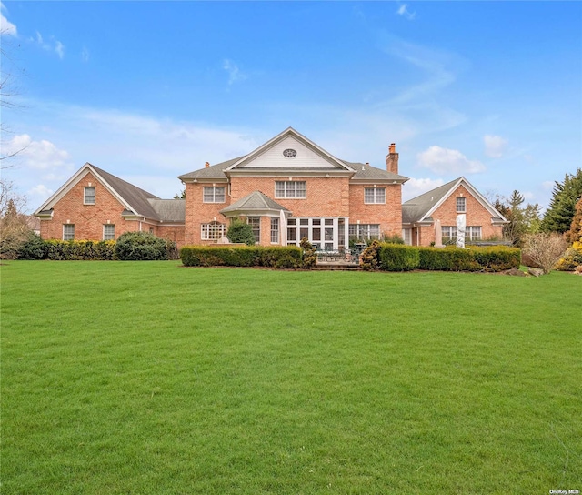 rear view of house with a lawn