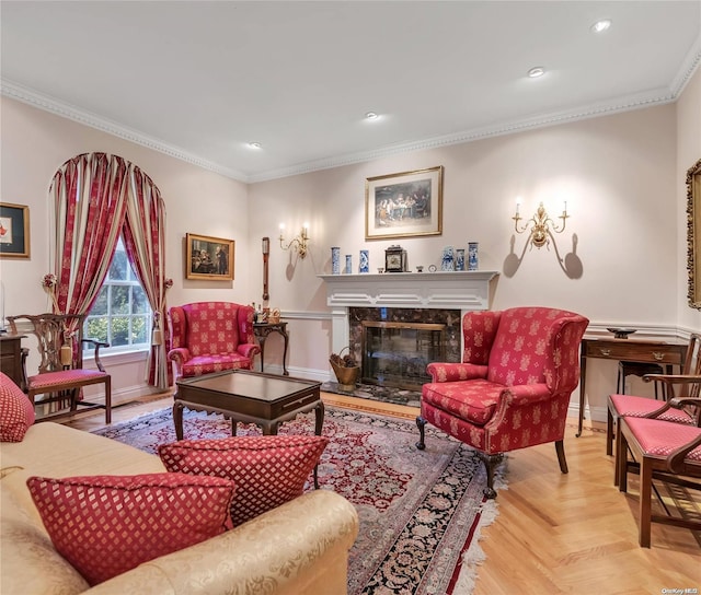 living room with light parquet flooring, a high end fireplace, and ornamental molding