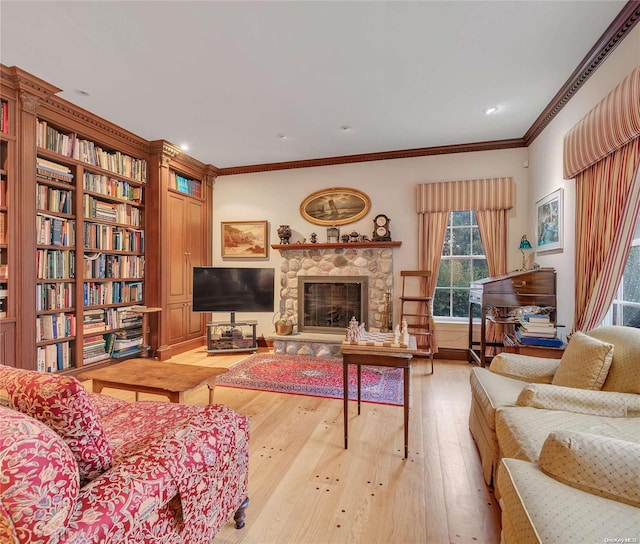 living room featuring a stone fireplace, light hardwood / wood-style flooring, and ornamental molding