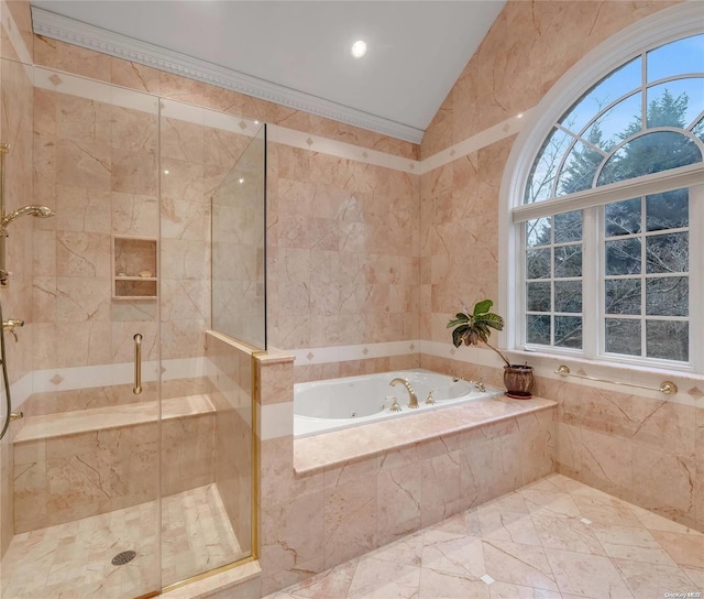 bathroom with tile walls, lofted ceiling, shower with separate bathtub, and ornamental molding