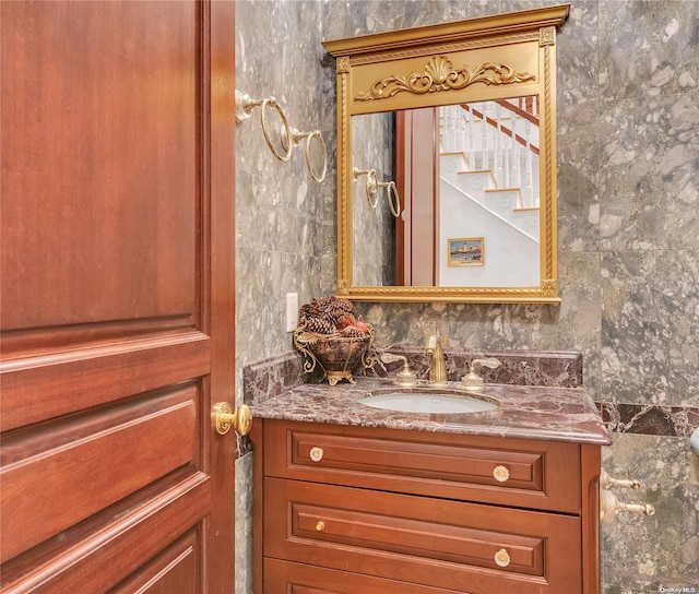 bathroom featuring vanity and backsplash