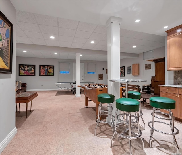 interior space with light carpet and a drop ceiling