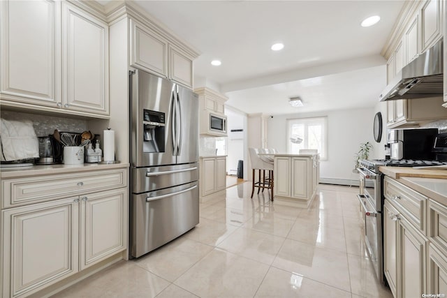 kitchen featuring appliances with stainless steel finishes, tasteful backsplash, ventilation hood, light tile patterned floors, and cream cabinetry