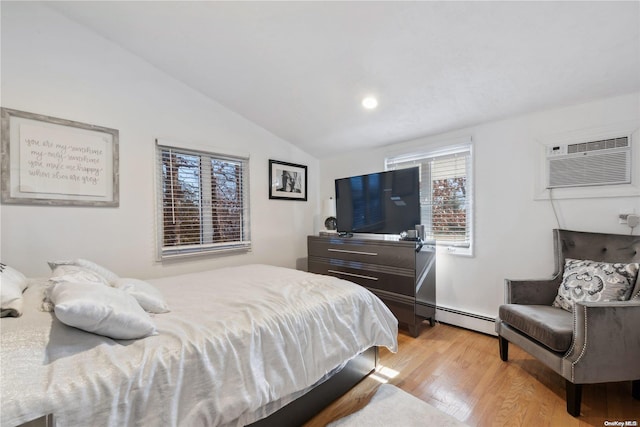 bedroom featuring multiple windows, light hardwood / wood-style flooring, a baseboard radiator, and vaulted ceiling