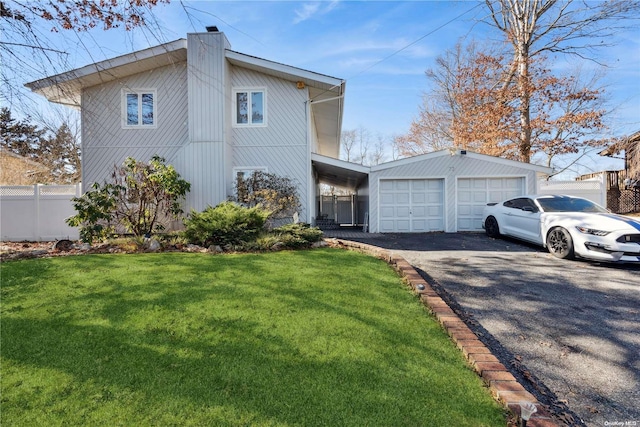 view of front facade featuring a front yard and a garage