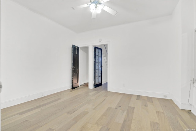 empty room with ceiling fan and light wood-type flooring