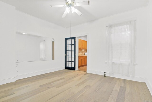 spare room with ceiling fan and light hardwood / wood-style floors