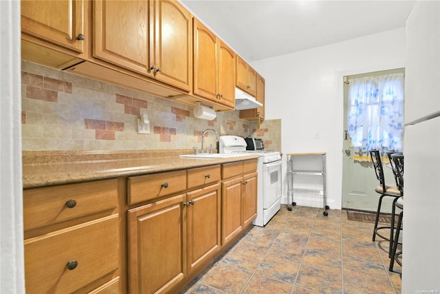 kitchen with backsplash, white range oven, and sink